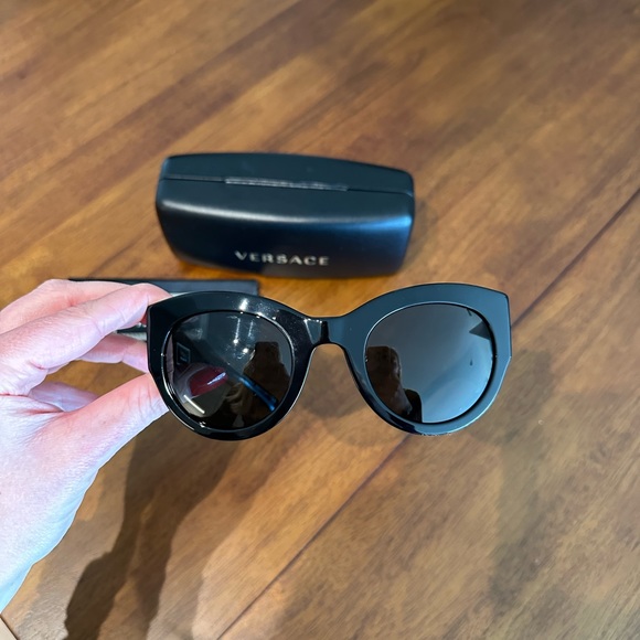 Versace black sunglasses with gold emblem on both sides main image 2